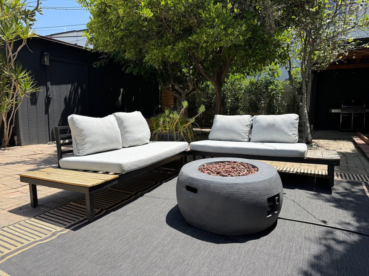 The outdoor lounge sofas around the fire pit in daylight