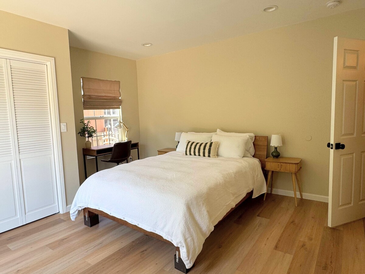 Primary bedroom with a queen memory foam bed in bright light