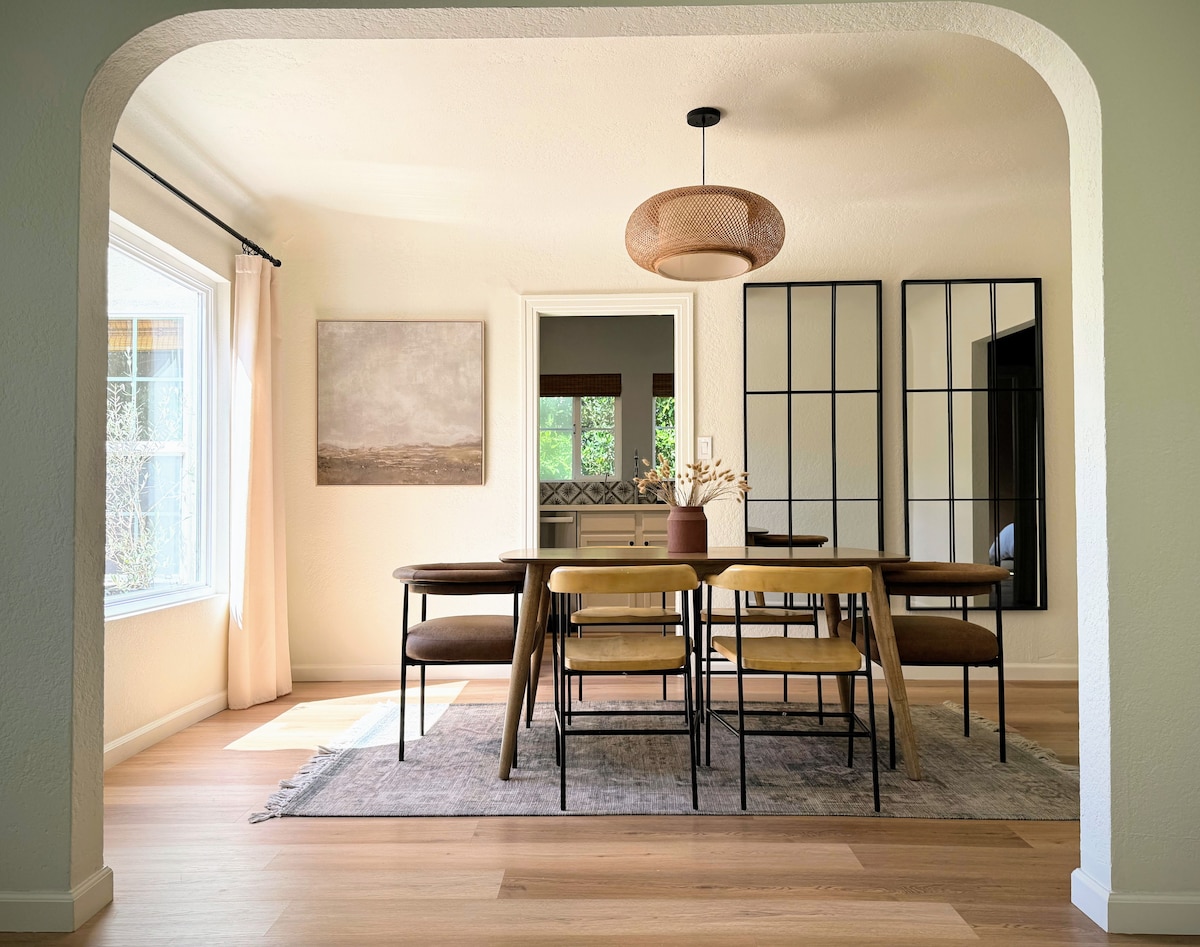 Dining room framed by an arched opening and steel windows