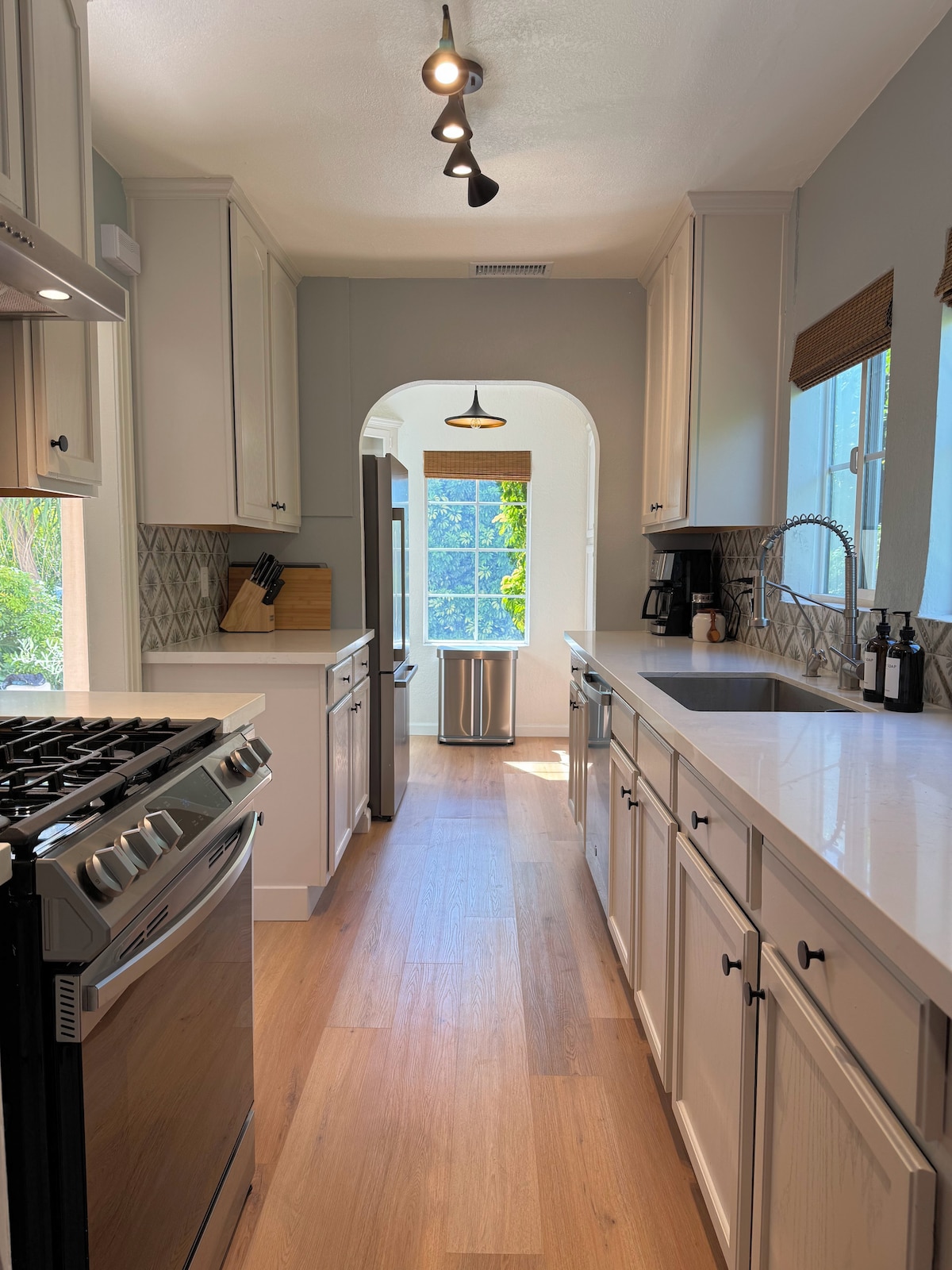Full kitchen with stone counters and a gas range